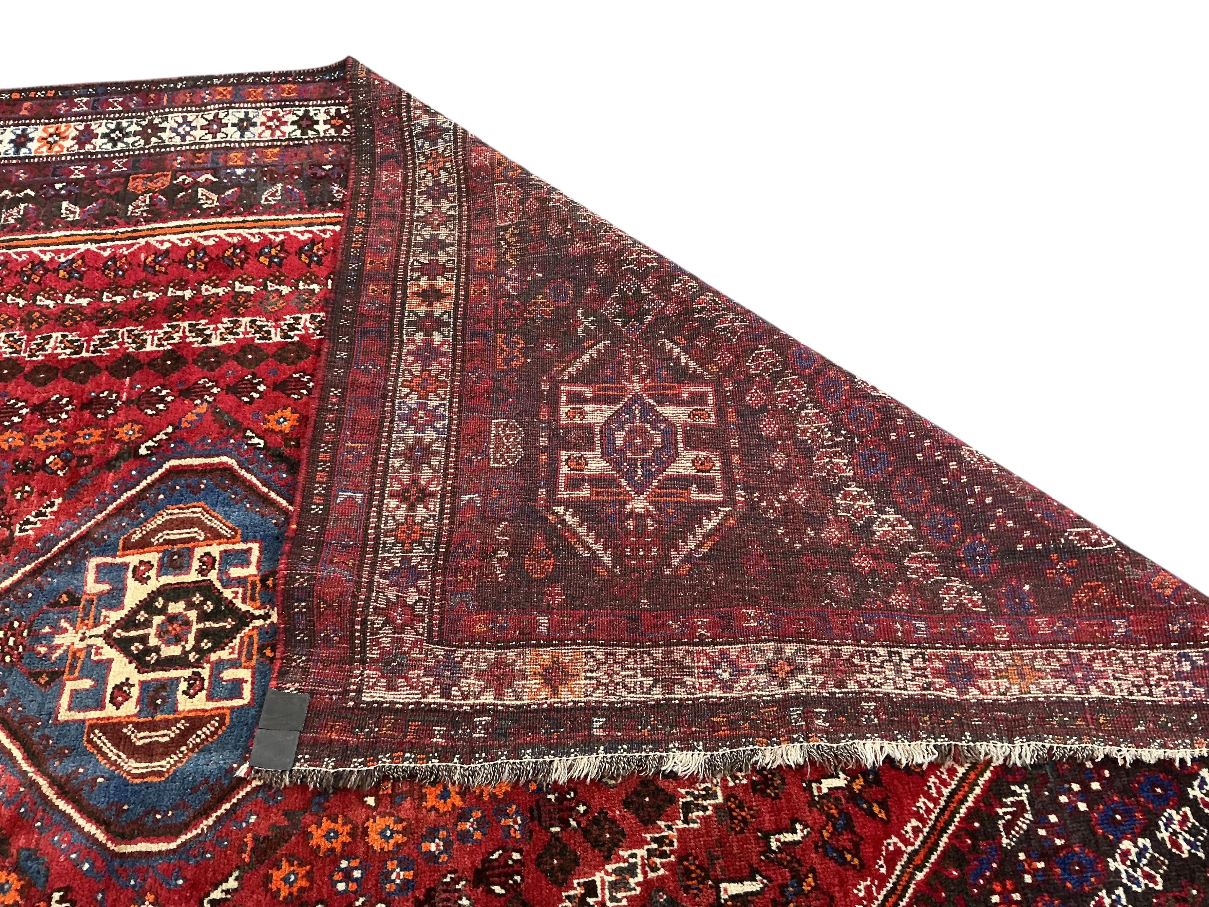 A Hamadan red ground carpet, 305 x 220cm.